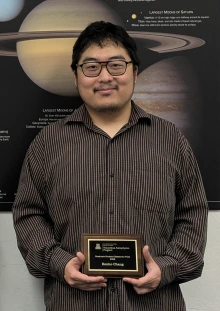 Eonho Chang  holding 2025 Research Prize Plaque